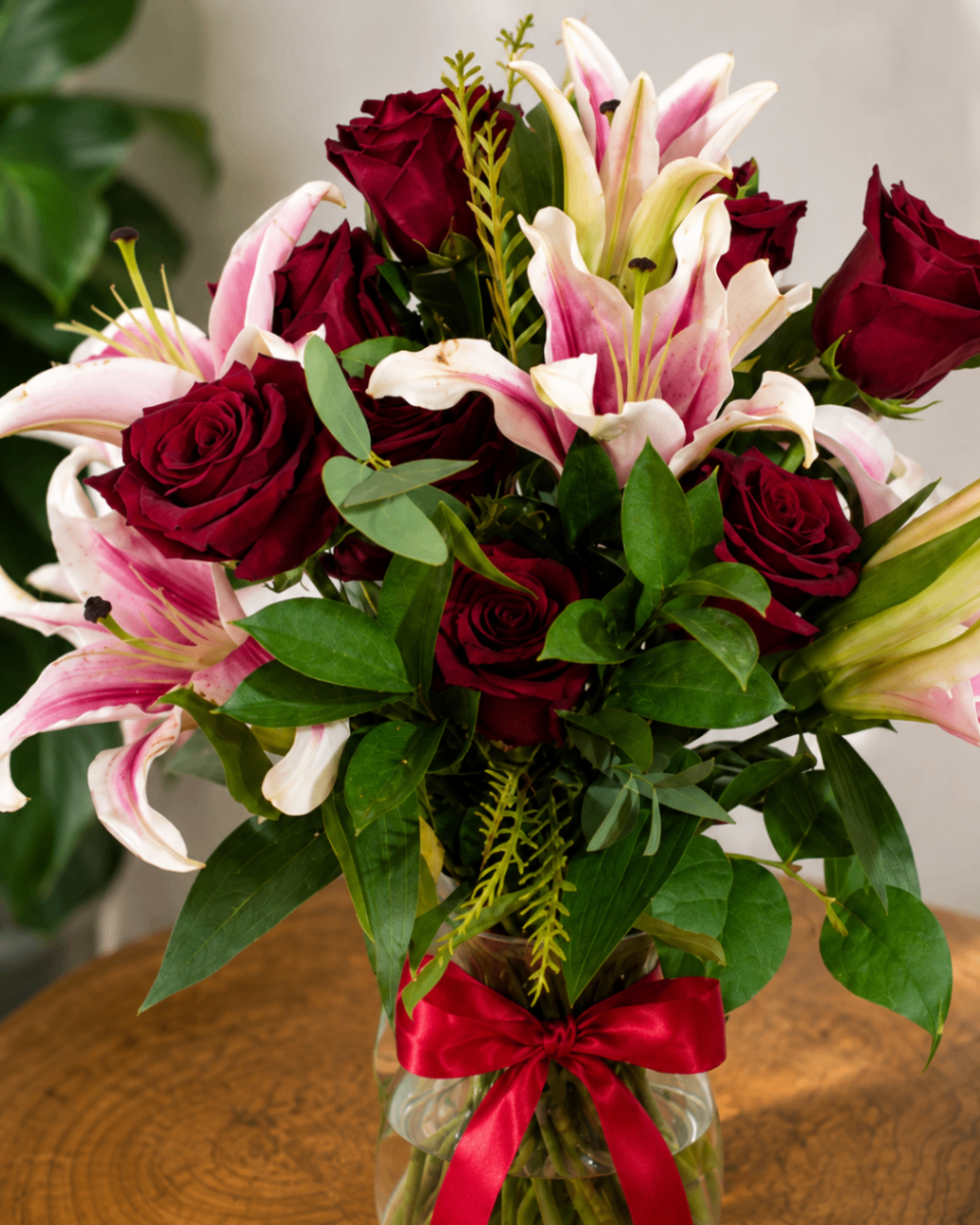 Red roses and pink lilies in a welcoming housewarming arrangement for a Dallas home.
